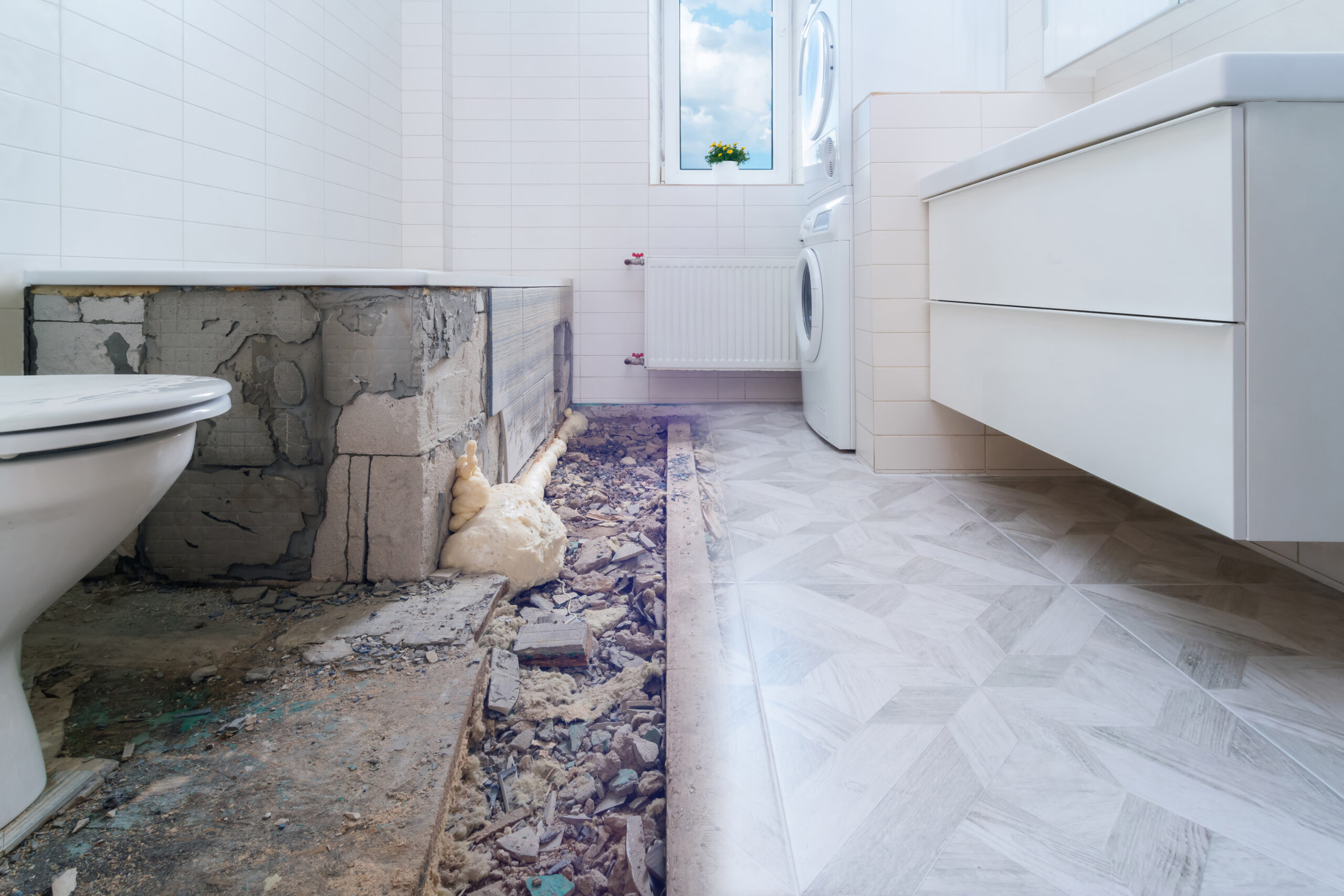 Bathroom renovation before and after. Laying new stone tiles in